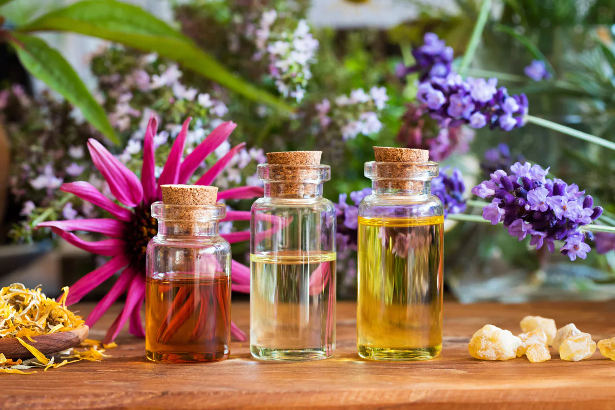 Essential Oils in Bottles showing surrounded by flowers