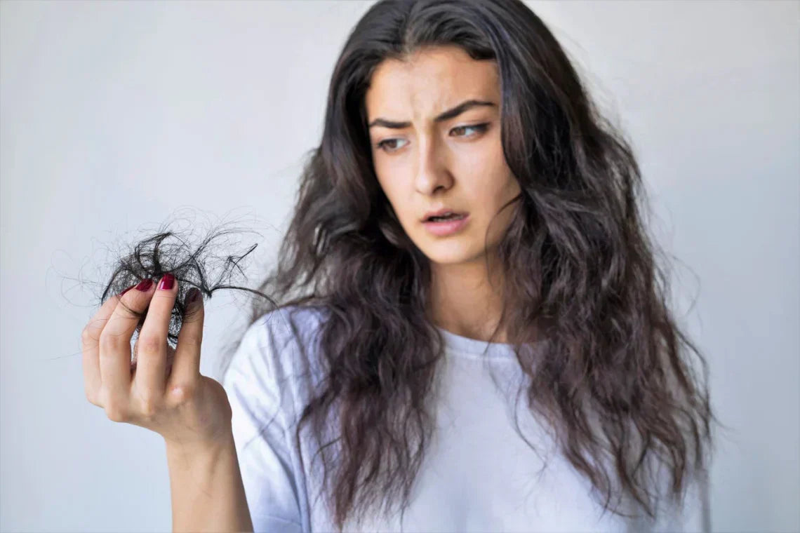 Women holding lost hair 