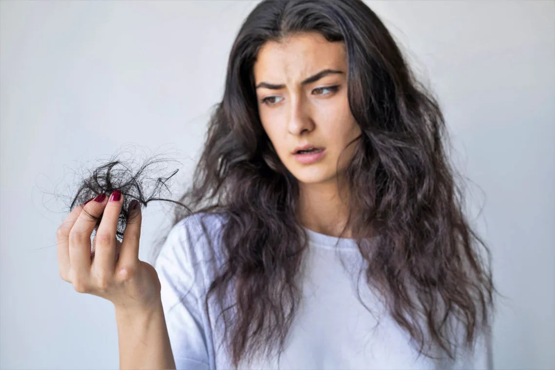 Women holding lost hair 